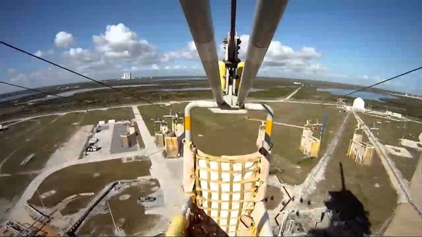 NASA Space Shuttle Last Second Zipline emergency evacuation baskets are released from the Launch Tower for